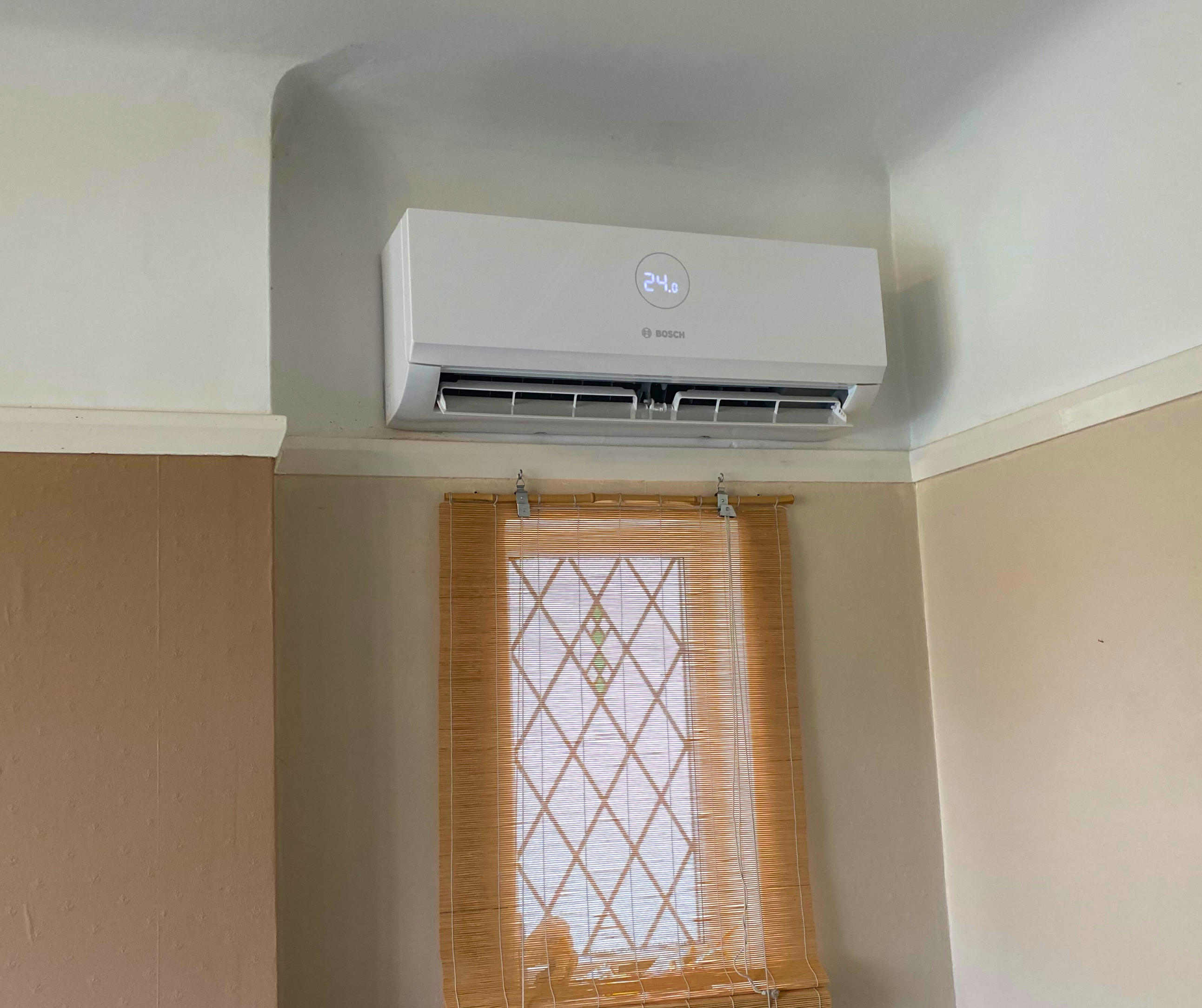 A sleek and modern air conditioning unit installed on a wall in a property on the Wirral, blending functionality with contemporary design.